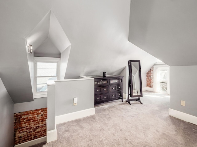 additional living space with lofted ceiling, carpet, and baseboards