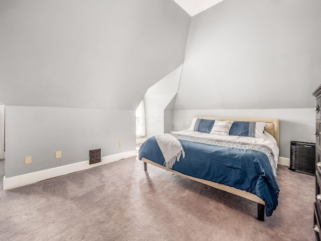 carpeted bedroom featuring vaulted ceiling and baseboards