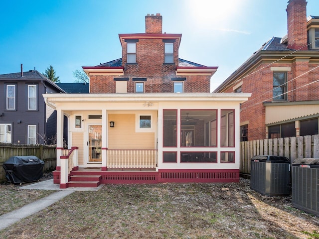 back of house with a sunroom, fence, central AC, and a chimney