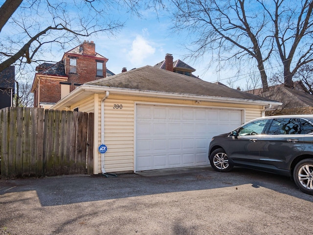 detached garage featuring fence