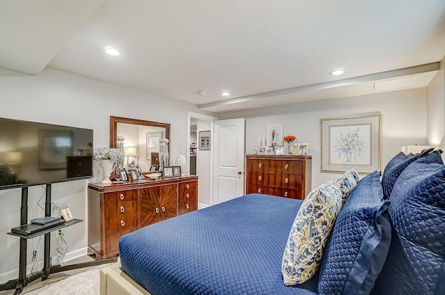 bedroom with wood finished floors, recessed lighting, and baseboards