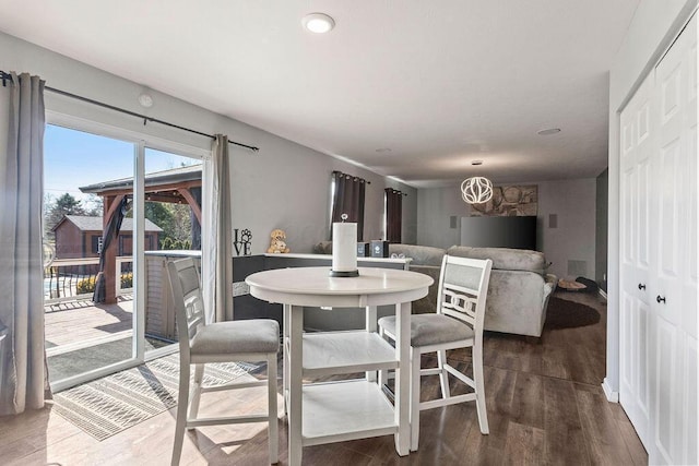 dining space featuring an inviting chandelier and wood finished floors