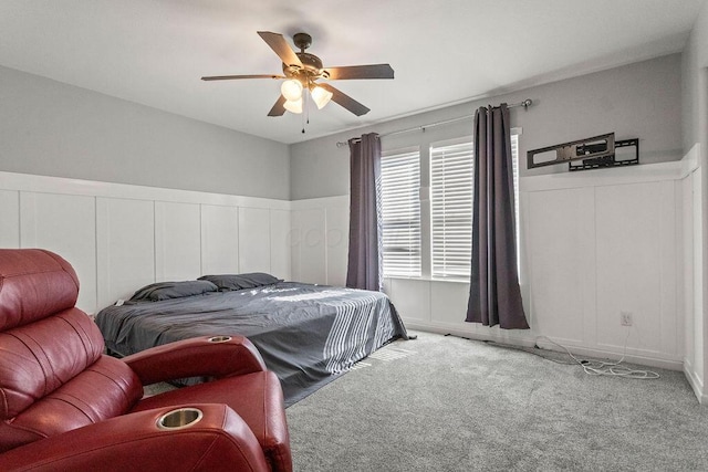 carpeted bedroom with a decorative wall and ceiling fan