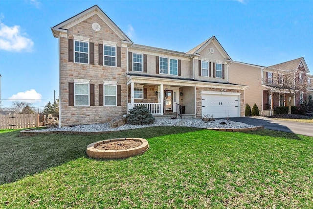 view of front of home with driveway, a porch, an attached garage, a front lawn, and stone siding