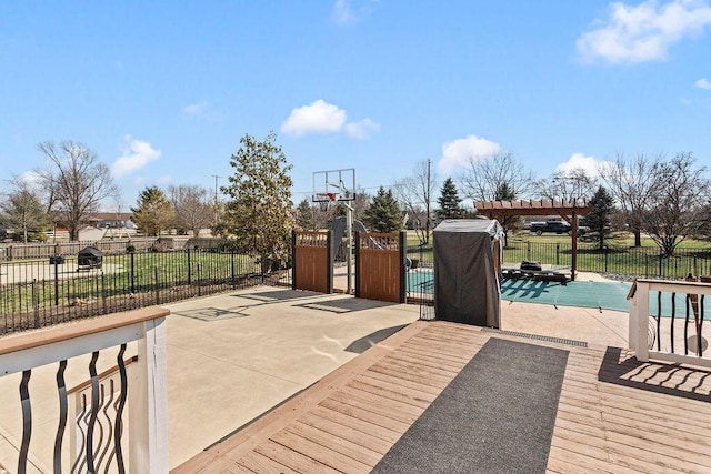 view of patio / terrace featuring a fenced in pool, basketball court, and fence