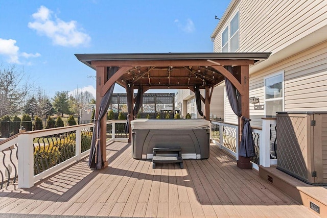 wooden deck featuring a gazebo and a hot tub