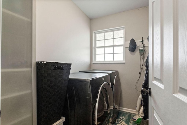 laundry room featuring laundry area, washing machine and dryer, and baseboards