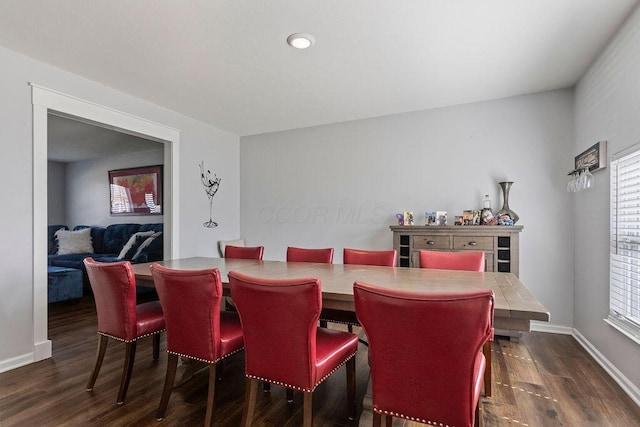 dining room featuring baseboards and dark wood finished floors