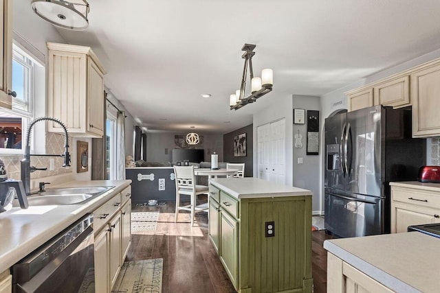 kitchen with tasteful backsplash, dishwasher, light countertops, dark wood-style floors, and a sink