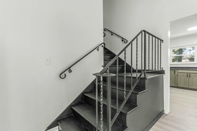 stairs with wood finished floors