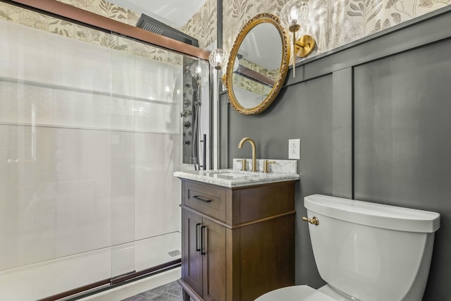 full bath featuring a stall shower, toilet, vanity, and wallpapered walls