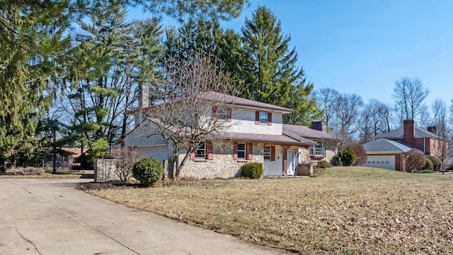 traditional-style home featuring stone siding, an attached garage, a chimney, and a front yard