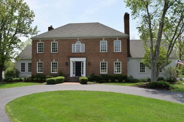 view of front of property with a chimney and a front yard