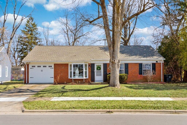 ranch-style home with brick siding, a garage, driveway, and a front lawn