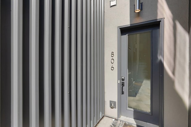 view of exterior entry featuring stucco siding