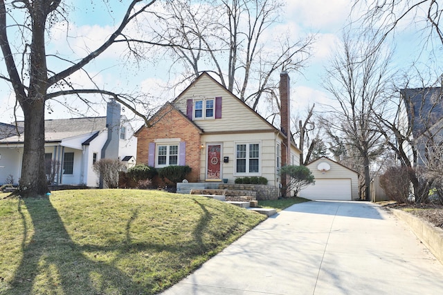 view of front facade featuring a front yard, a chimney, an outdoor structure, a detached garage, and brick siding