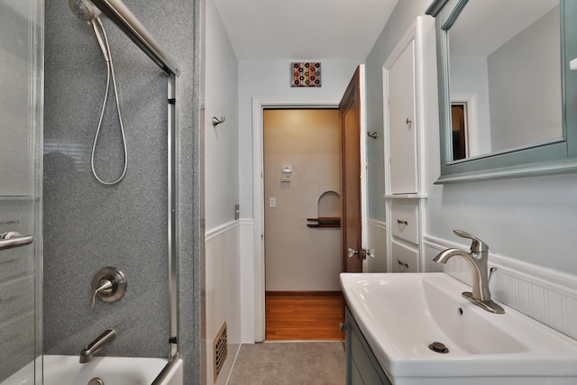 full bath featuring vanity, shower / bathing tub combination, visible vents, and wainscoting