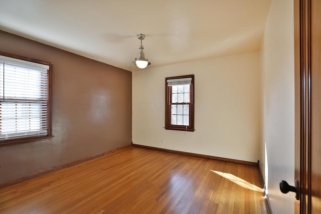 empty room with light wood-style flooring and baseboards