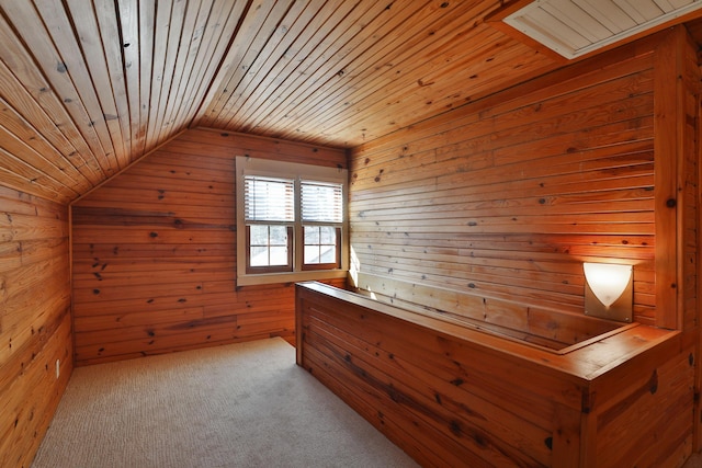 interior space featuring wooden walls, wooden ceiling, carpet flooring, and vaulted ceiling