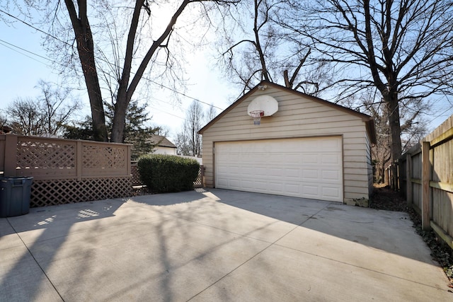 detached garage featuring fence