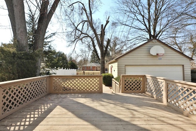 deck featuring a garage and an outbuilding