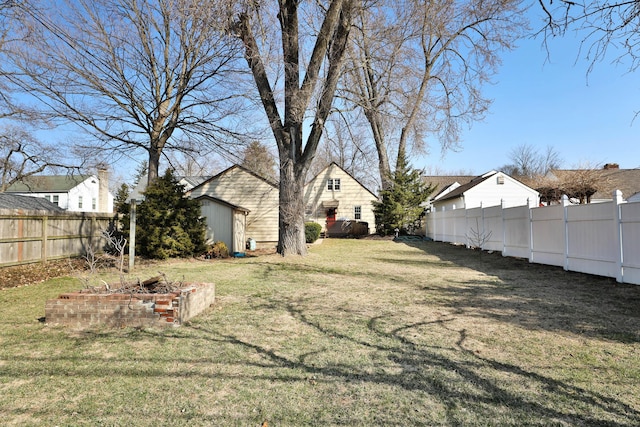 view of yard featuring an outdoor structure and a fenced backyard