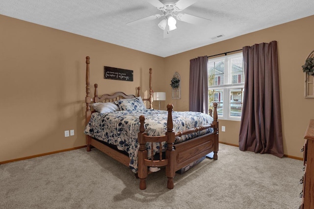 bedroom featuring visible vents, baseboards, carpet, and a textured ceiling