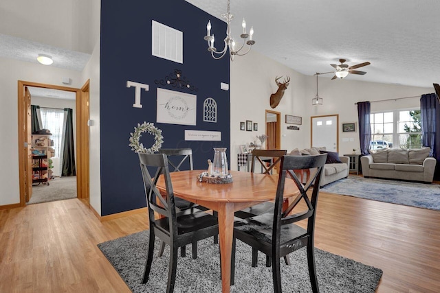 dining area with plenty of natural light, light wood finished floors, and a textured ceiling