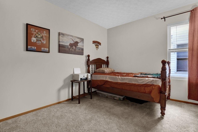 carpeted bedroom with baseboards and a textured ceiling