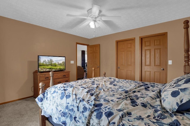 carpeted bedroom with baseboards, a textured ceiling, and ceiling fan