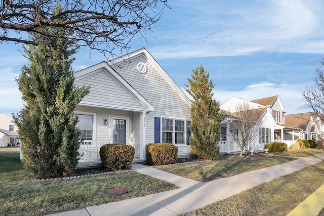 view of front of home with covered porch and a front lawn