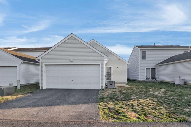 exterior space featuring a front yard, an attached garage, and driveway