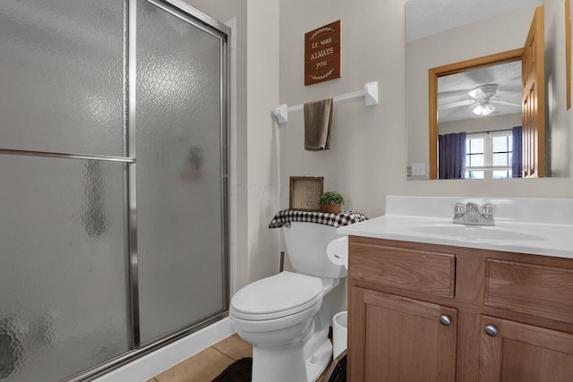 bathroom featuring tile patterned floors, a stall shower, and vanity