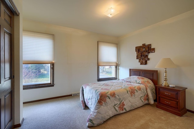 bedroom featuring light colored carpet, visible vents, and baseboards