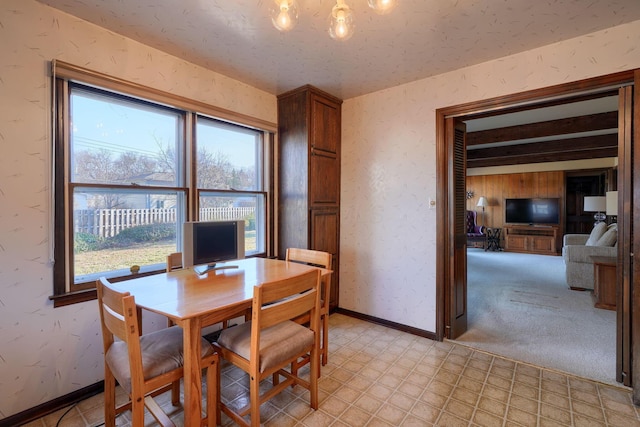 dining area with wallpapered walls and baseboards