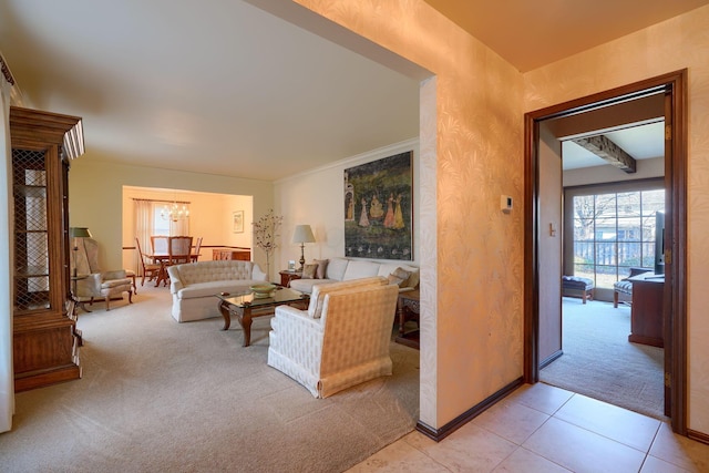 living room with crown molding, light tile patterned floors, baseboards, light colored carpet, and a chandelier