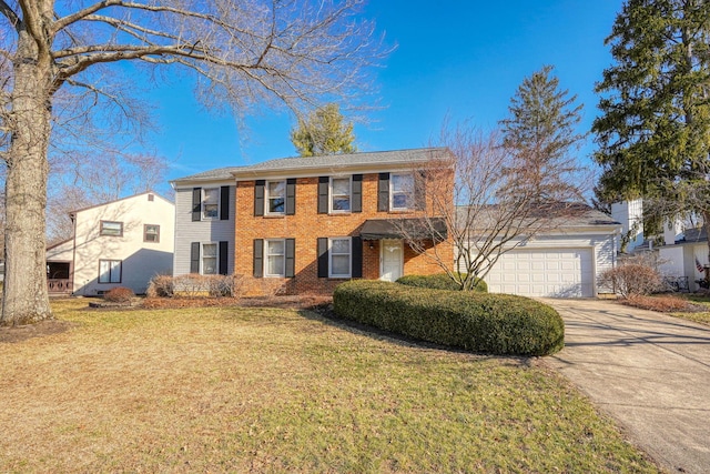 colonial inspired home with brick siding, driveway, a front lawn, and a garage