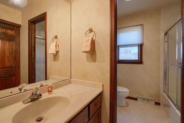 bathroom with visible vents, baseboards, toilet, tile patterned floors, and vanity