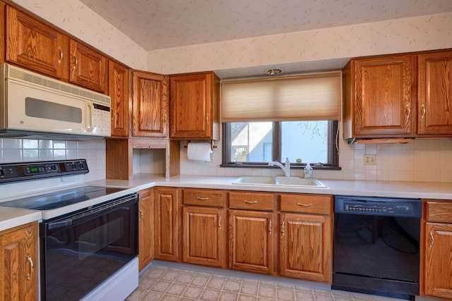 kitchen featuring white microwave, wallpapered walls, a sink, electric range oven, and dishwasher