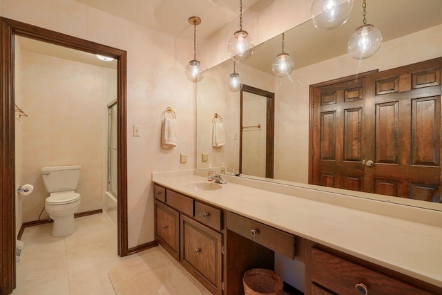 full bath featuring vanity, baseboards, tile patterned floors, toilet, and combined bath / shower with glass door