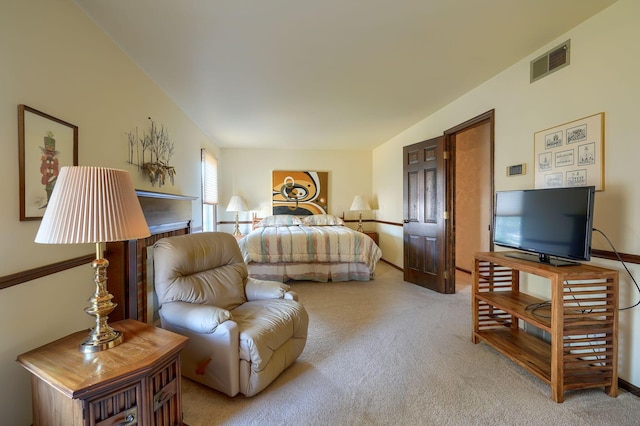 bedroom featuring visible vents, light carpet, and baseboards