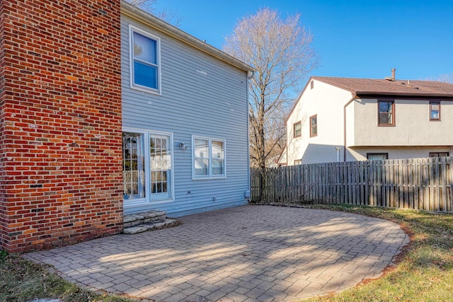 back of house featuring entry steps, a patio, and fence