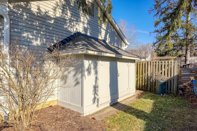 view of shed featuring fence