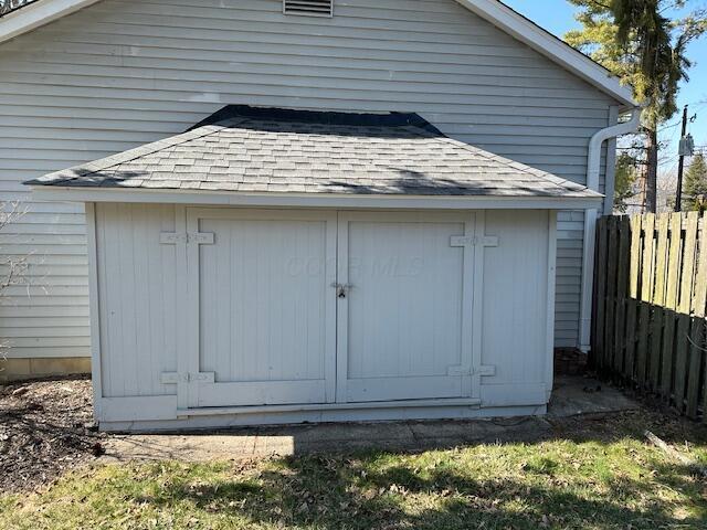 view of shed featuring fence