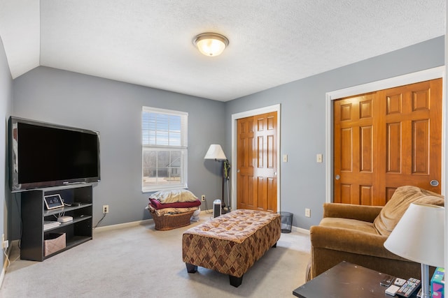 carpeted living room with a textured ceiling, lofted ceiling, and baseboards