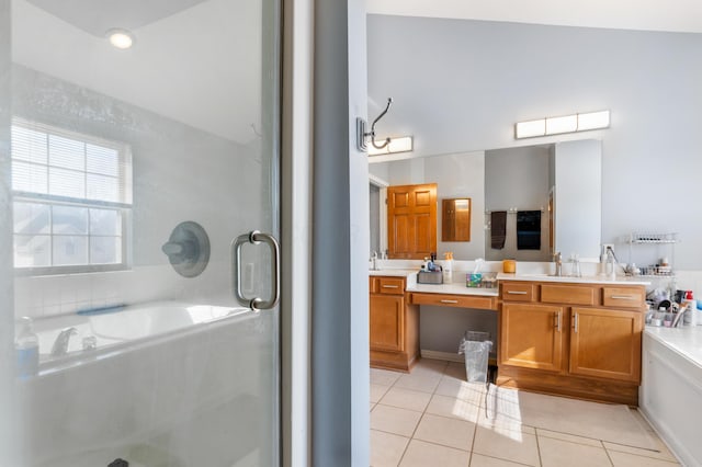 full bathroom featuring double vanity, a sink, tile patterned flooring, an enclosed shower, and a garden tub