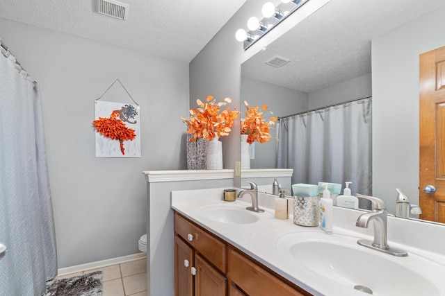 full bathroom featuring tile patterned floors, visible vents, and a sink