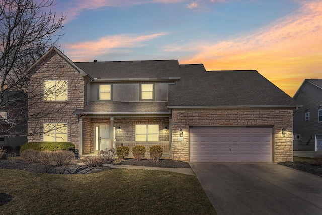 traditional home featuring stone siding, a porch, roof with shingles, concrete driveway, and an attached garage