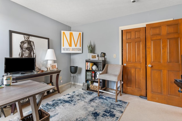 carpeted office space featuring baseboards