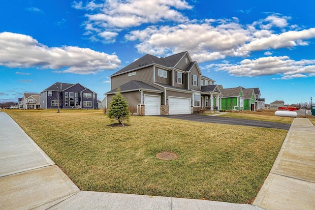 view of front of house with aphalt driveway, a residential view, a garage, and a front lawn